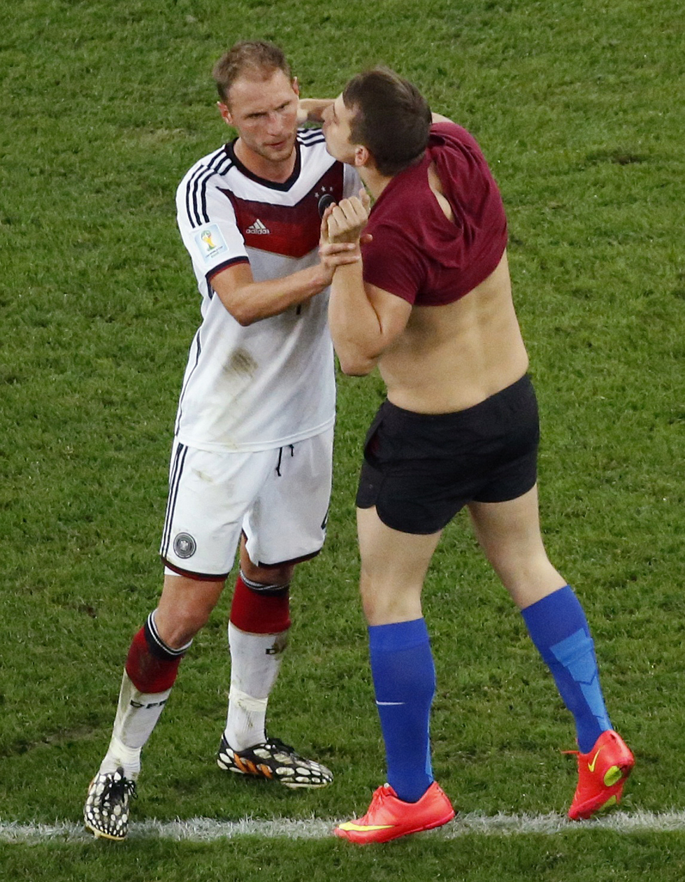 A fan tries to kiss Germany's Benedikt Hoewedes during their 2014 World Cup final against Argentina at the Maracana stadium in Rio de Janeiro